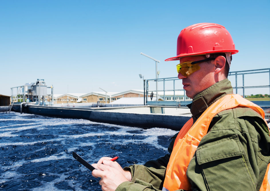 engineers,working,on,water,treatment,plant,with,laptop,and,measuring