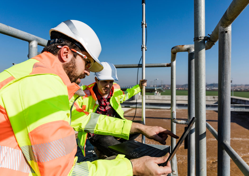 engineers,working,on,water,treatment,plant,with,laptop,and,measuring